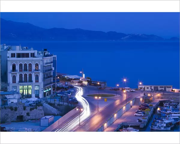 GREECE-CRETE-Iraklio Province-Iraklio: Dawn Traffic on Plateia 18 Anglon Square by