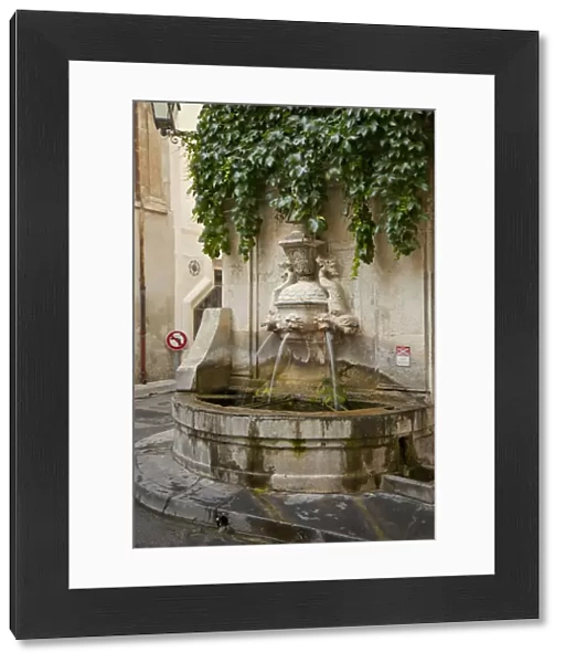 France, Provence, St. Remy-de-Provence. Water fountain on street corner. Credit as