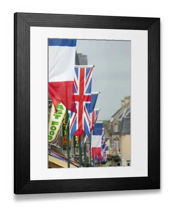 Framed Print : France, Normandy, Arromanches. Ceremonial flags line the streets of Normandy for