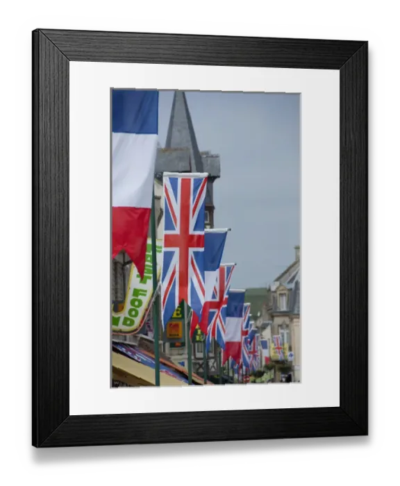 Framed Print : France, Normandy, Arromanches. Ceremonial flags line the streets of Normandy for