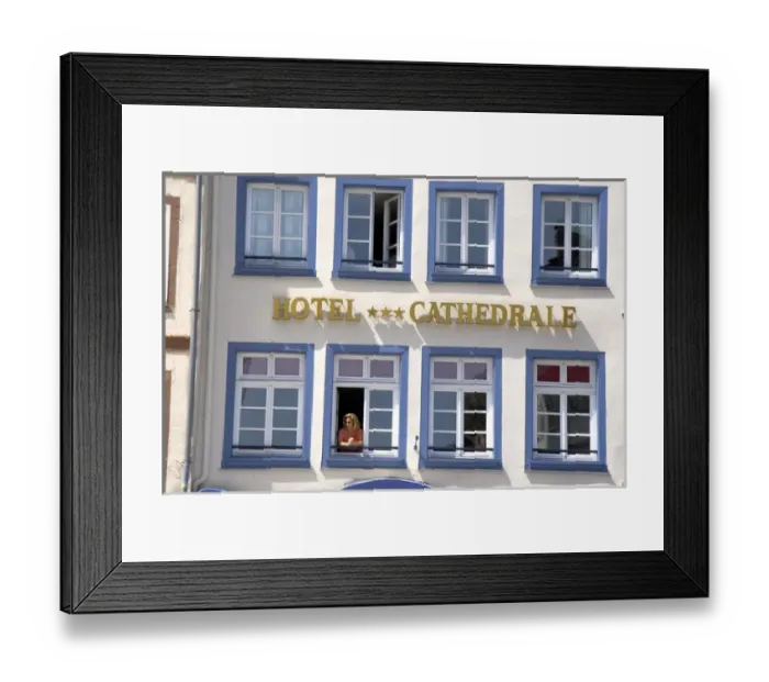 Framed Print : Woman looking out the window of the Cathedral Hotel at Strasbourg, France