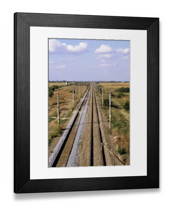 Framed Print : Bucharest, Romania. Electrified railway line with fresh laid ballast stretching into Framed Print : Bucharest, Romania. Electrified railway line with fresh laid ballast stretching into