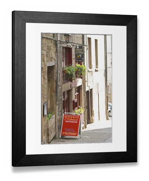 Framed Print : A street scene in Vinenne, a restaurant called lEstancot in the old town, with a sign Framed Print : A street scene in Vinenne, a restaurant called lEstancot in the old town, with a sign