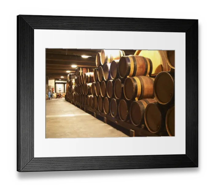 Framed Print : Wooden barrels with aging wine in the cellar of Guigal in Ampuis. Domaine E Guigal