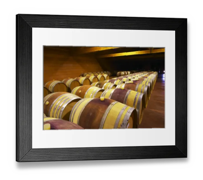 Framed Print : The barrel aging cellars with rows of oak barrels. All are painted red