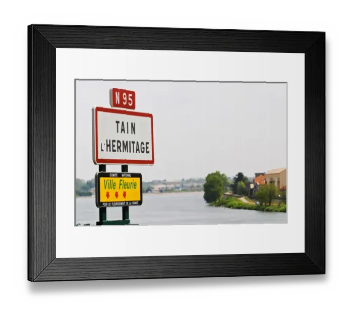 Framed Print : A road sign at the entrance to the town Tain l Hermitage. Tain laaHermitage