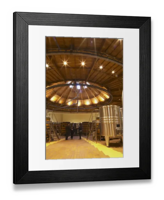 Framed Print : The winery with wooden and stainless steel fermentation vats. It is built in a circular design Framed Print : The winery with wooden and stainless steel fermentation vats. It is built in a circular design