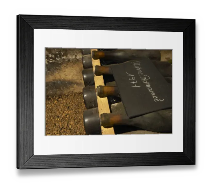 Framed Print : In the underground wine cellar: a pile of bottles of Vosne Romanee Romanee 1971 red