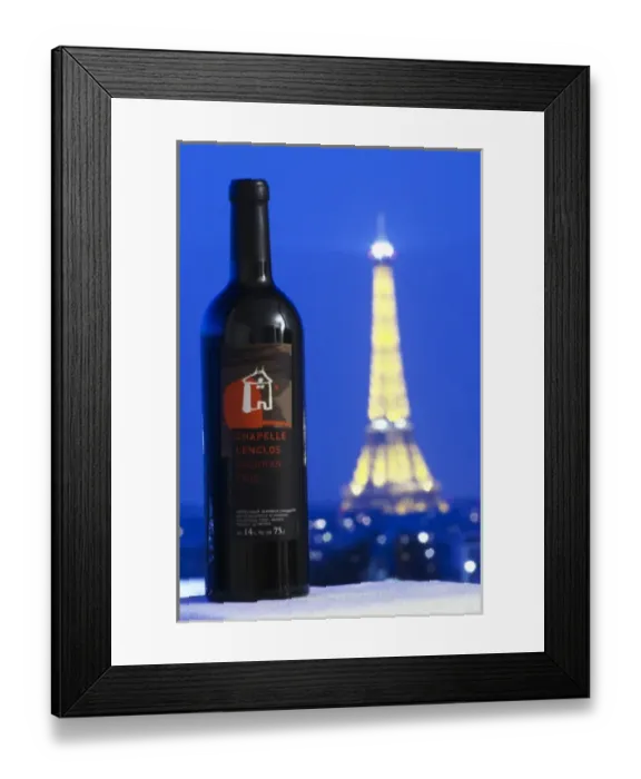 Framed Print : Bottle of Chapelle Lenclos against a dark blue sky background view over Paris with Framed Print : Bottle of Chapelle Lenclos against a dark blue sky background view over Paris with