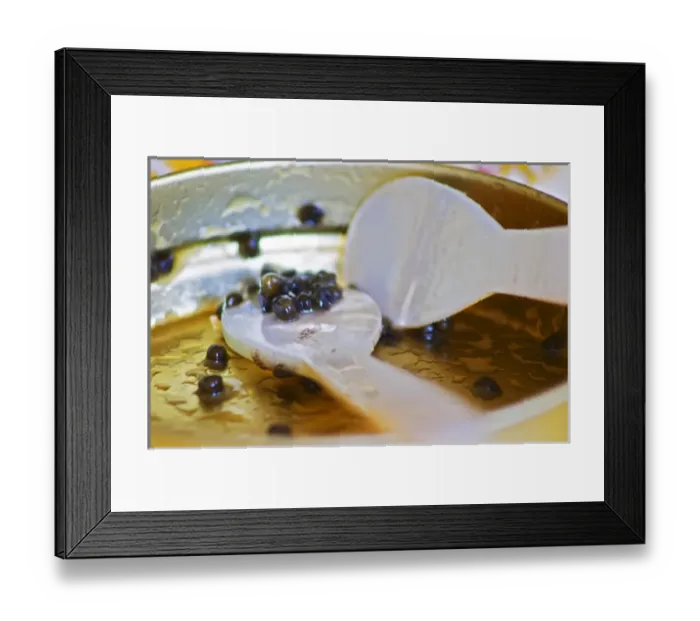 Framed Print : An empty tin of sturgeon caviar with two mother of pearl spoons and only a few grains