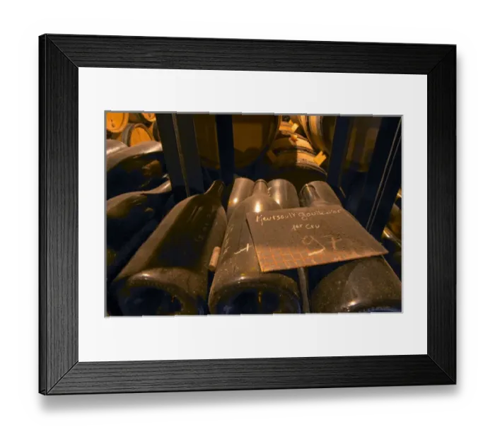 Framed Print : Bottles and barrels in the cellar of Domaine Alain Coche Bizouard in Meursault, Bourgogne