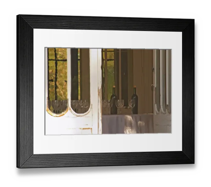 Framed Print : Door open to the garden with inside a table set with glasses and bottles for tasting wine Framed Print : Door open to the garden with inside a table set with glasses and bottles for tasting wine