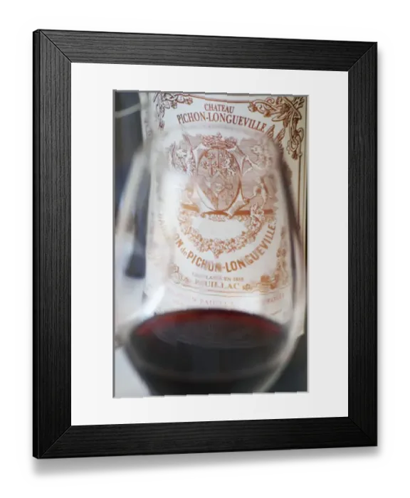 Framed Print : A glass of wine with the label of a bottle seen through the glass - label without vintage Framed Print : A glass of wine with the label of a bottle seen through the glass - label without vintage