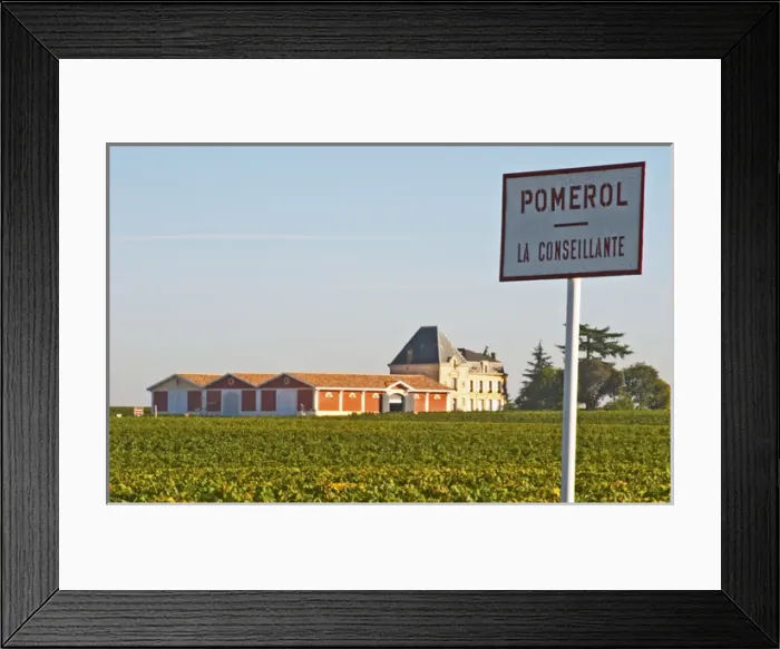 Framed Print : Pomerol vineyards - A sign with La Conseillante, with the chateau Evangile with winery