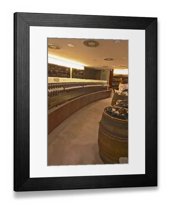 Framed Print : A curved display of bottles and a barrel used to present bottles The Lavinia wine shop in Paris