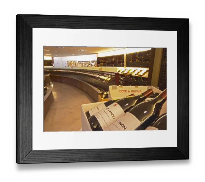 Framed Print : A curved display of bottles. In the foreground bottles of Le Canon SARL La Grande