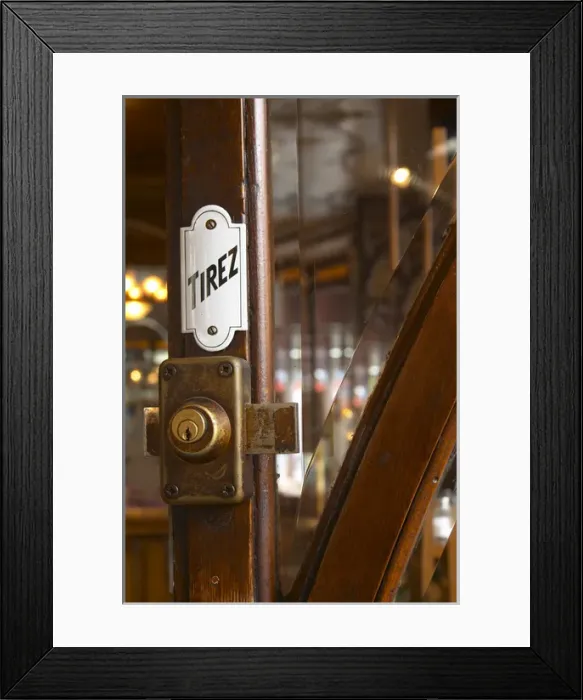 Framed Print : Detail of a door with a brass lock an enamel sign saying tirez (pull)