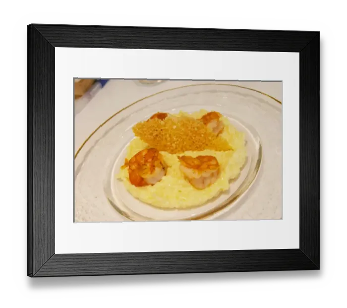Framed Print : A creamy risotto with confit lemon and thyme grilled scampis on a glass plate with