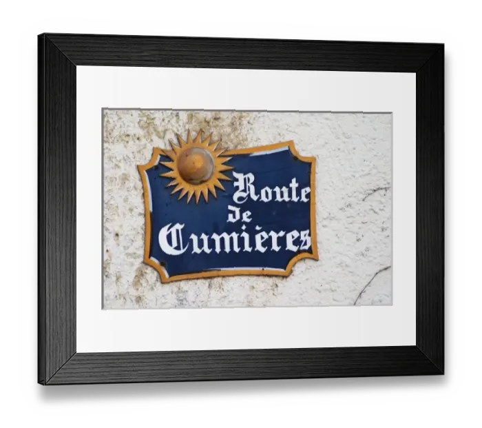 Framed Print : A blue street sign on a white wall in the village that indicates the road to