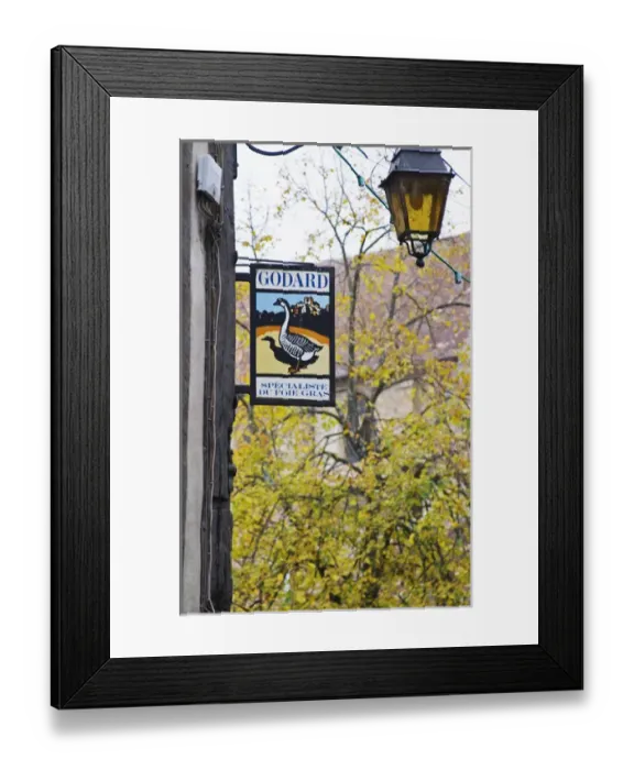 Framed Print : Sign advertising Godard Foie Gras, Duck or Goose fat liver. Tree and lantern in background Framed Print : Sign advertising Godard Foie Gras, Duck or Goose fat liver. Tree and lantern in background