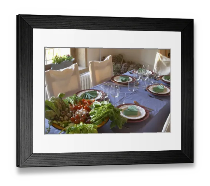 Framed Print : The dining room table decorated and set with flowers and decorative vegetables for dinner guests Framed Print : The dining room table decorated and set with flowers and decorative vegetables for dinner guests