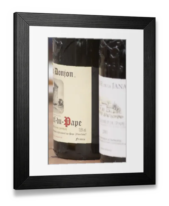 Framed Print : Bottle of Domaine Donjon. The restaurant Le Verger de Papes in the village Framed Print : Bottle of Domaine Donjon. The restaurant Le Verger de Papes in the village