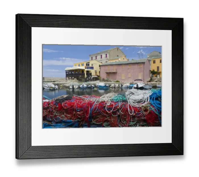 Framed Print : Corsica. France. Europe. Fishing nets stacked on dock at village of Centuri. Cap Corse Framed Print : Corsica. France. Europe. Fishing nets stacked on dock at village of Centuri. Cap Corse