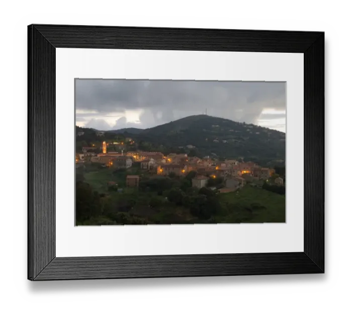 Framed Print : Europe, France, Corsica, Piana. Lights of Piana at dusk with storm clouds