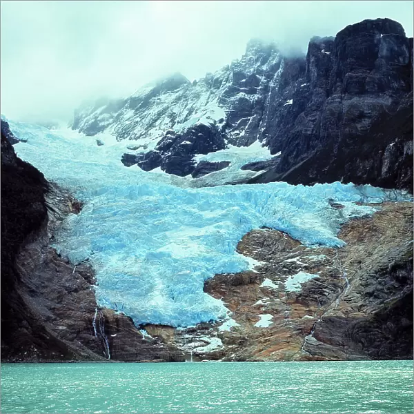 South America, Chile, Ultima Esperanza Fjord. The blue ice of Balmaceda Glacier creeps