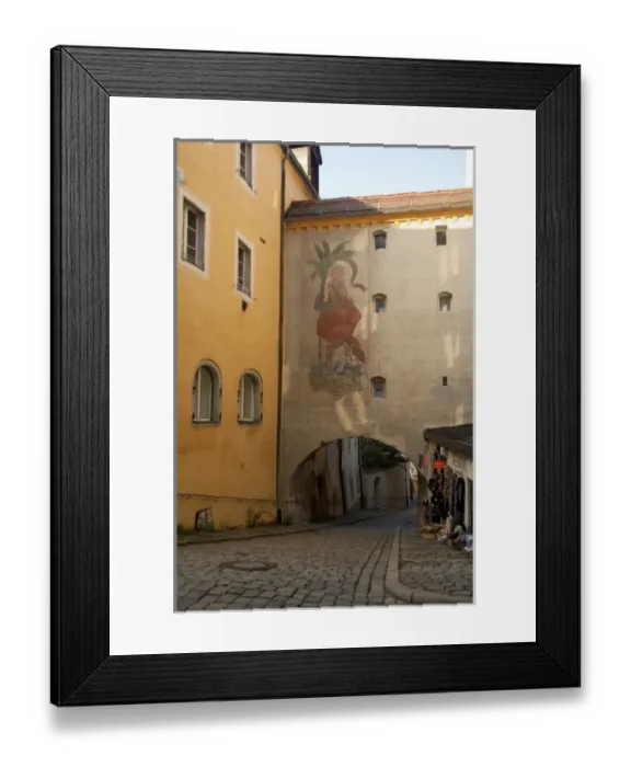 Framed Print : Germany, Passau. Typical narrow cobblestone street of Passau, historic wall painting Framed Print : Germany, Passau. Typical narrow cobblestone street of Passau, historic wall painting
