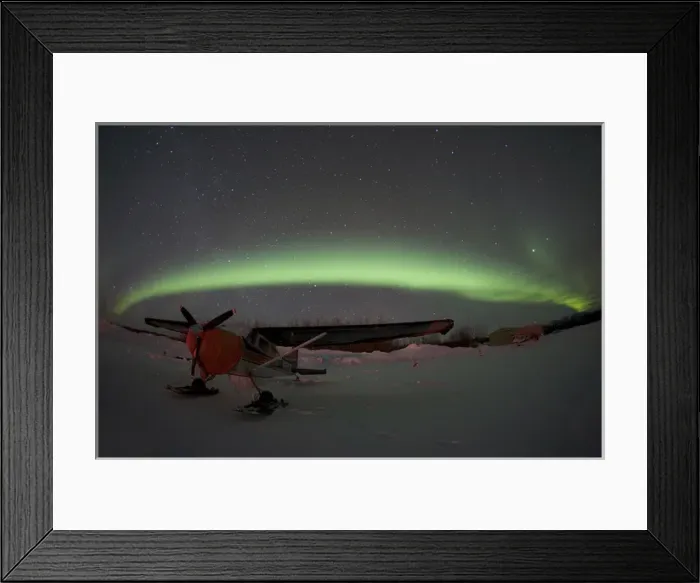 Framed Print : USA, Alasaka, Bettles. An airplane waits out the night beneath the northern lights