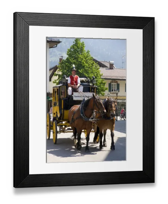 Framed Print : Street scene with a horse drawn stage coach in the alpine village of Garmisch, Germany