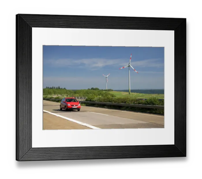 Framed Print : Electricity wind generators and automobiles traveling on the autobahn in northwest