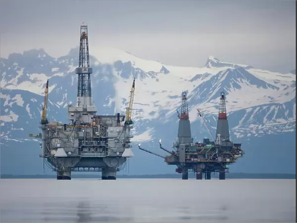 USA, Alaska, Offshore oil drilling rigs in Cook Inlet and distant Alaska Range peaks