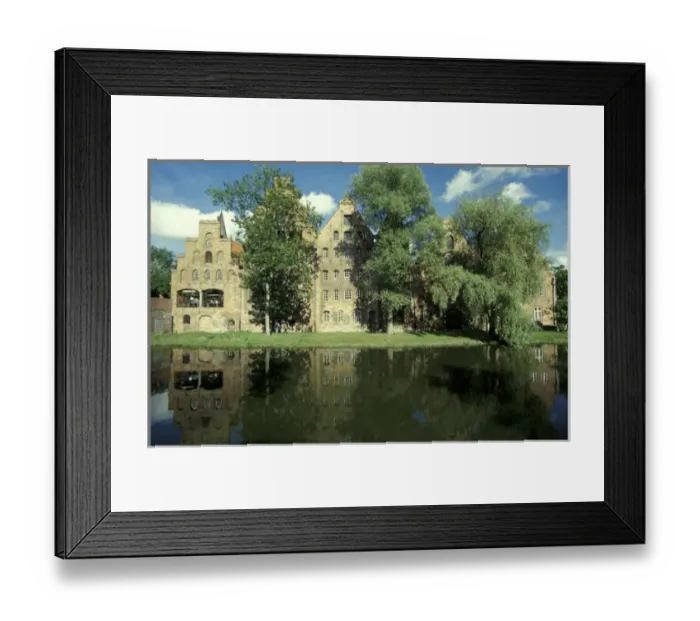 Framed Print : Europe, Germany, Lubeck. Old salt storage building reflecting on the river