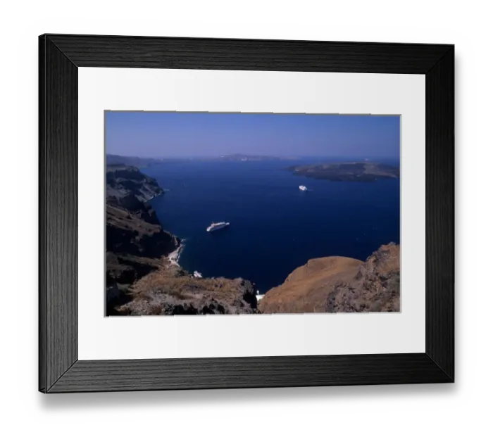 Framed Print : Looking down from Santorini at cliffs and cruise ship in Mediterranean Framed Print : Looking down from Santorini at cliffs and cruise ship in Mediterranean