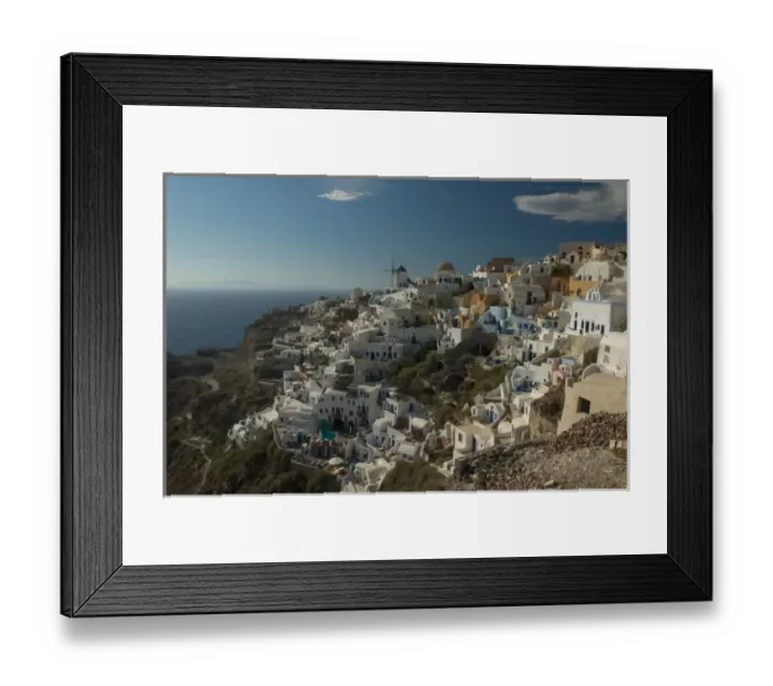 Framed Print : Europe, Greece, Cyclades, Santorini: the villge of Oia perches atop a clifftop overlooking