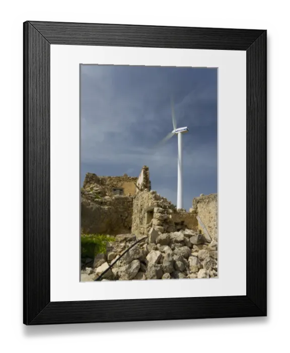 Framed Print : Crete. Greece. Europe. Wind turbine of Plastika Kritis wind farm towers above ruins
