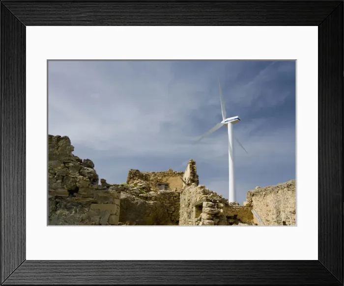 Framed Print : Crete. Greece. Europe. Wind turbine of Plastika Kritis wind farm towers above ruins