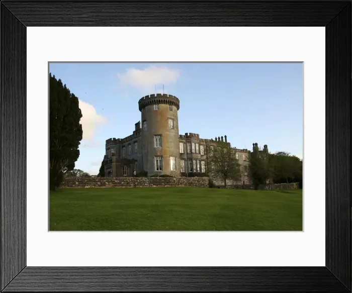 Framed Print : In Ireland, the Dromoland Castle turret grounds and green lawn with blue sky white clouds