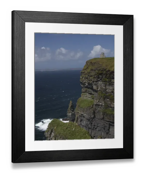Framed Print : Scenic Cliffs of Moher and O Briens Tower under a blue sky and white puffy Framed Print : Scenic Cliffs of Moher and O Briens Tower under a blue sky and white puffy