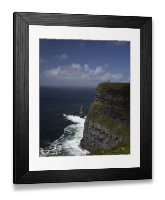 Framed Print : Distant scenic of the Cliffs of Moher and O Briens Tower under a blue sky Framed Print : Distant scenic of the Cliffs of Moher and O Briens Tower under a blue sky