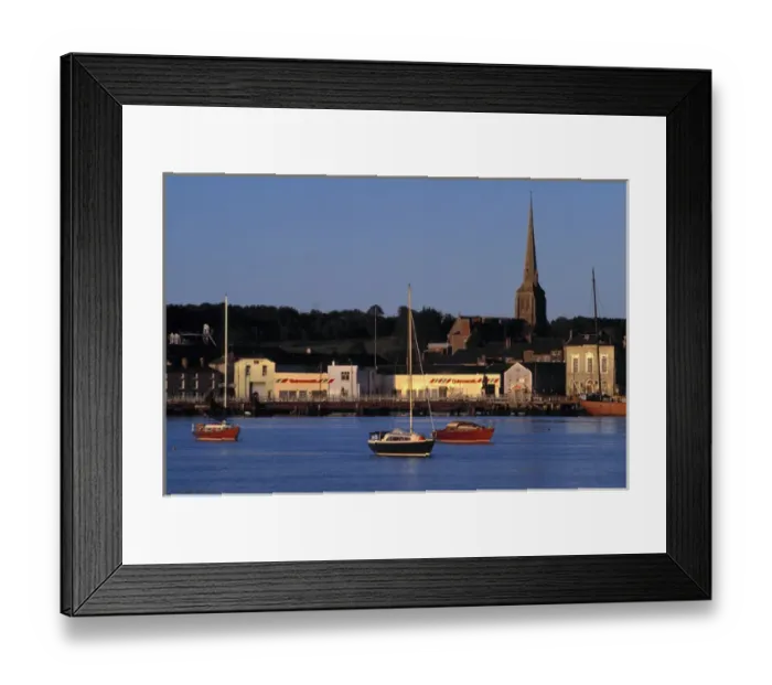 Framed Print : Europe, Ireland, Wexford. Late golden light plays off the boats and buildings on Wexford Harbor