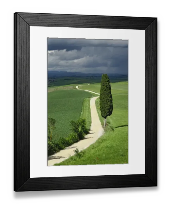 Framed Print : Road winding through agricultural region of Tuscany with storm clouds, Italy Framed Print : Road winding through agricultural region of Tuscany with storm clouds, Italy