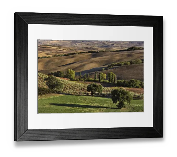 Framed Print : Sunset light on rolling agricultural hills of Tuscany after the harvest, San Quirico