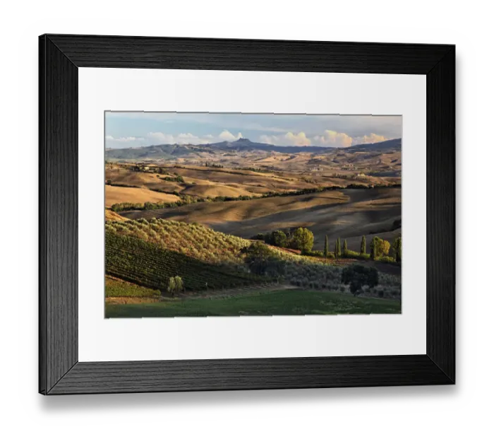 Framed Print : Sunset light on rolling agricultural hills of Tuscany after the harvest, San Quirico