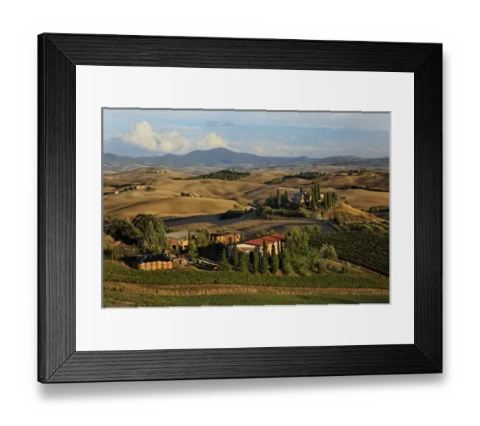 Framed Print : Sunset light on rolling agricultural hills of Tuscany after the harvest, San Quirico