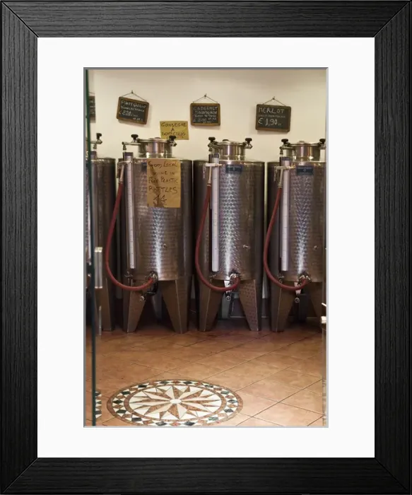 Framed Print : Venice, Veneto, Italy - A row of shiny metal vats containing wine for sale in bulk
