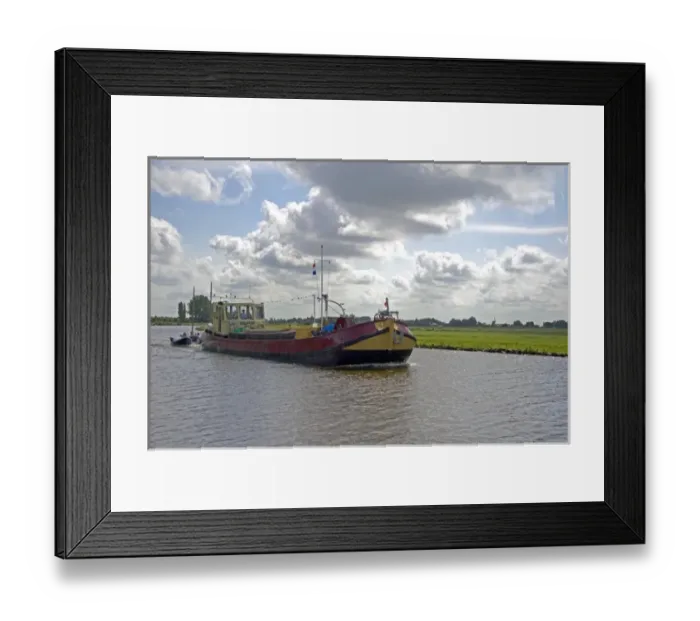 Framed Print : Boat traveling on a canal east of Leiden in the province of South Holland, Netherlands Framed Print : Boat traveling on a canal east of Leiden in the province of South Holland, Netherlands