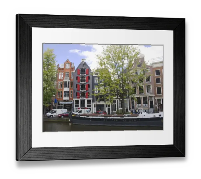 Framed Print : Colorfu buildings line an Amsterdam canal with a houseboat parked out front Framed Print : Colorfu buildings line an Amsterdam canal with a houseboat parked out front